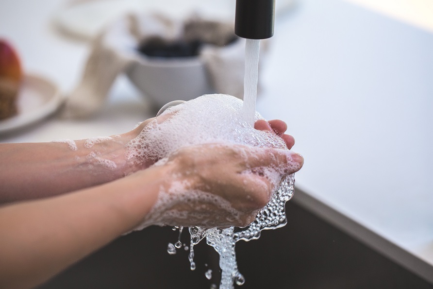 Photo of someone washing their hands under running water